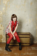 Attractive woman sitting on a suitcase