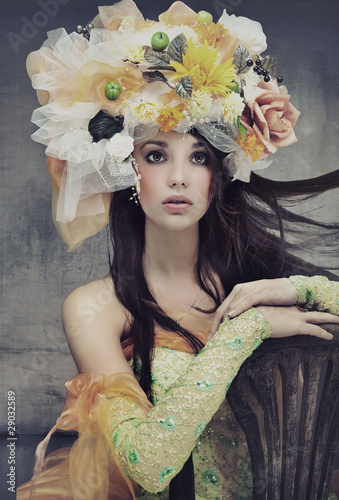 Photo: Stunning brunette beauty sitting on a chair Stunning brunette beauty sitting on a chair