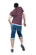 Young man dancing. Rear view.