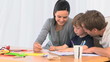Parents looking at their son drawing