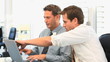 Coworkers working together on a laptop