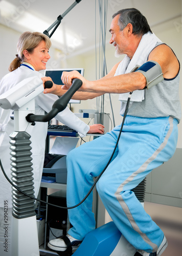 Photo: Patient is being observed by doctor - EKG test Patient is being observed by doctor - EKG test