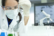 Photo: Female Scientist or Woman Doctor With Test Tube In Laboratory Female Scientist or Woman Doctor With Test Tube In Laboratory