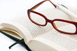Glasses on book and pen isolated in white Glasses on book and pen isolated in white