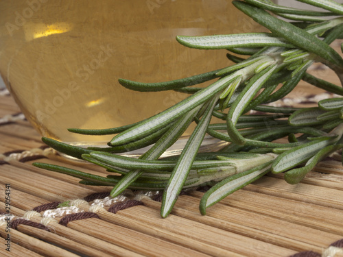 Photo: fresh rosemary with warm massage oil in a spa fresh rosemary with warm massage oil in a spa