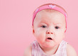 Portrait of the beautiful surprised girl on a pink background
