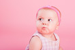 Portrait of the beautiful serious girl on a pink background