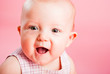 Portrait of the small child on a pink background