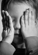 Photo : BW portrait of sad crying little boy covers his face with hands BW portrait of sad crying little boy covers his face with hands
