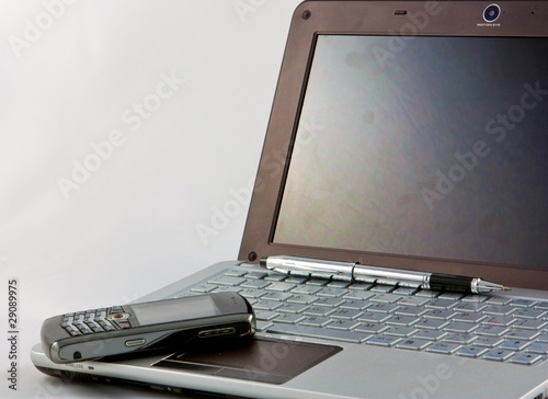 Photo: laptop, phone and pen on white background laptop, phone and pen on white background