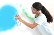 woman paints the wall