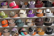 fancy leather belts rolled up on shelf displayed for sale