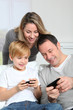 Photo: Family playing video game on smartphone Family playing video game on smartphone