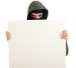 male thief in mask and hood with blank sign, billboawd