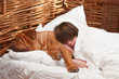 Young woman and her giant dog comfortably sleeping in the bed