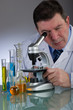 man  look in the microscope at laboratory