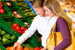 Couple in supermarket shopping groceries