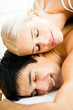 Young attractive happy amorous couple at bedroom