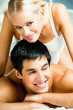 Young attractive happy amorous couple at bedroom
