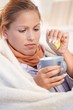 Young female caught cold drinking tea feeling bad