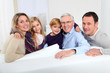 Portrait of happy family sitting in sofa at home