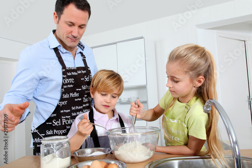 Photo: Father and children preparing pancakes Father and children preparing pancakes