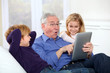 Photo: Grandfather with kids using electronic tab Grandfather with kids using electronic tab