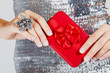red gift box in woman's hands.