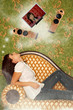 Girl in jeans sits on sofa and dreams about hi-fi system at wall Girl in jeans sits on sofa and dreams about hi-fi system at wall
