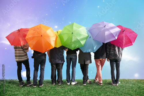 Photo : seven friends with rainbow color umbrellas on meadow collage seven friends with rainbow color umbrellas on meadow collage