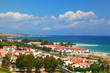 Borough of city on coast including small white dwellings