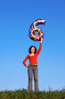 Girl holds in outstretched arm above head figure of six Girl holds in outstretched arm above head figure of six