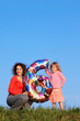 Mother and daughter holding an inflatable figure of six Mother and daughter holding an inflatable figure of six