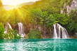 Waterfalls in national park in sun rays. Plitvice, Croatia