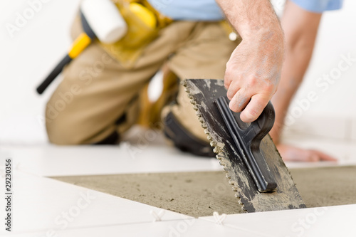 Photo: Home improvement, renovation - handyman laying tile Home improvement, renovation - handyman laying tile