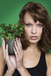 Young woman holding pot of ivy