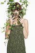 Woman with ivy covering her face