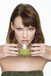 Young woman holding glass of wheatgrass juice