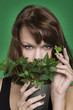 Young woman holding pot of ivy