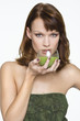 Young woman holding glass of wheatgrass juice