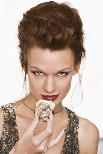 Photo: Young woman eating oyster Young woman eating oyster