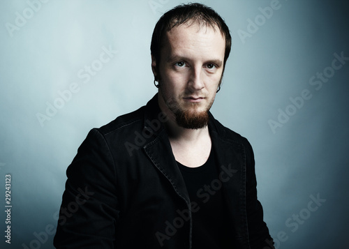 Photo: Artistic dark portrait of the young beautiful man with dark eyes Artistic dark portrait of the young beautiful man with dark eyes
