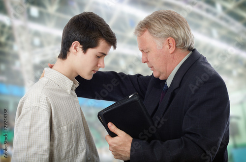 Photo: Preacher leading a young man in prayer to receive Lord Jesus Preacher leading a young man in prayer to receive Lord Jesus