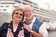 Senior Couple On Shore in Front of Cruise Ship
