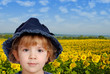 little girl portrait with sunflower field behind