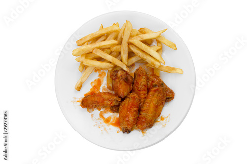 Photo: Plate of Hot Wings and Fries on White Background Plate of Hot Wings and Fries on White Background