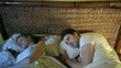 young couple sleeping in bed