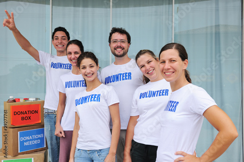 Photo: happy volunteer group with food donation happy volunteer group with food donation