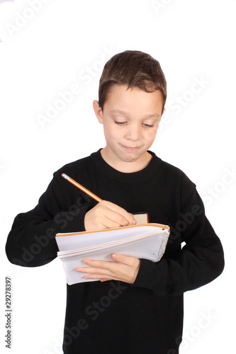 Photo: Boy writing in notebook Boy writing in notebook