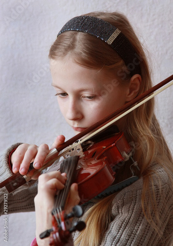 Photo: The girl plays a violin The girl plays a violin